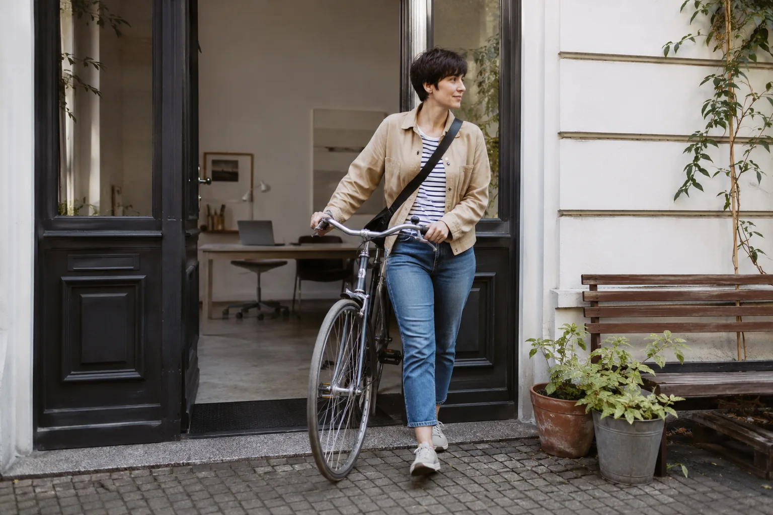 Eine Frau verlässt am Nachmittag mit ihrem Fahrrad den Arbeitsplatz